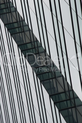 Angled green and blue glass of skyscraper