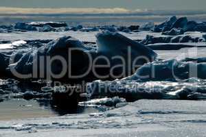 Backlit blue iceberg in the Arctic Ocean