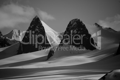 Black and white cliffs on snowy glacier