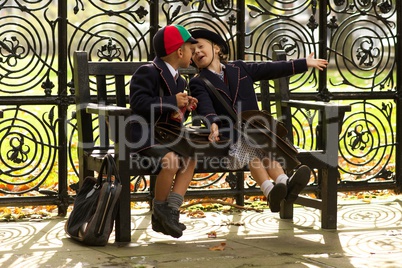 Brother and sister playing on wooden bench