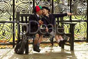 Brother and sister playing on wooden bench