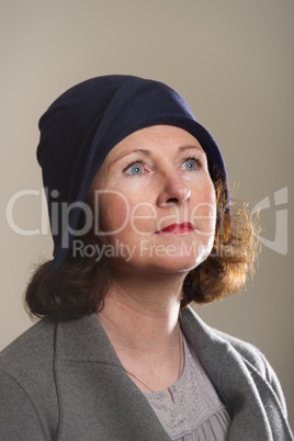 Brunette in blue cloche hat looking up