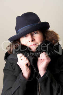 Brunette in blue hat and black jacket