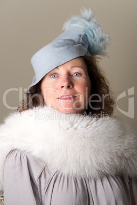 Brunette in blue feathered hat and fur