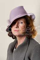 Brunette in lavender hat and grey jacket