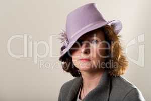 Brunette in lavender hat over one eye