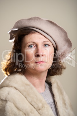 Brunette in taupe hat and fur stole