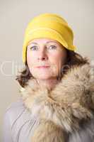 Brunette in yellow cloche hat and fur
