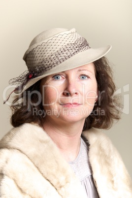 Brunette smiling in beige hat and fur