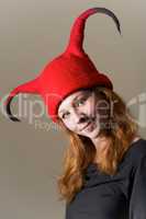 Cheeky redhead in funny red felt hat