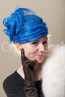Cheeky redhead in hat with leather glove
