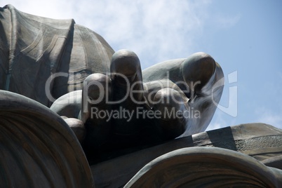 Close-up of Big Buddha fingers against sky