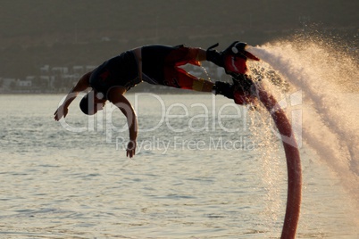 Close-up of Flyboarder in mid-air during dive