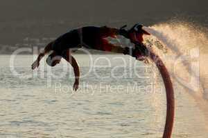 Close-up of Flyboarder in mid-air during dive