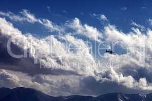 Helicopter in cloudy sky