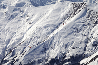 Paragliders of snowy mountains