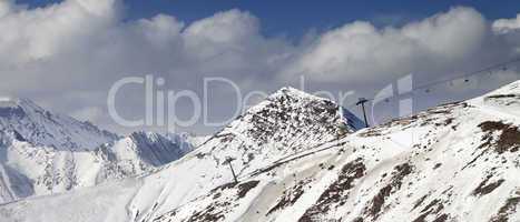 Off-piste slope and chair-lift in little snow year. Panoramic vi