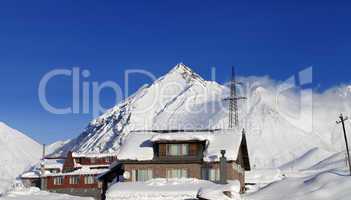 Hotels in winter snowy mountains at sun day