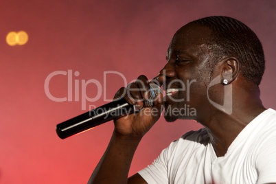 Close-up of black singer Akon on stage