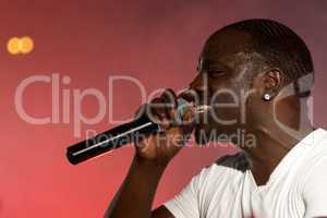 Close-up of black singer Akon on stage