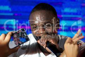 Close-up of black singer Akon with iPhone