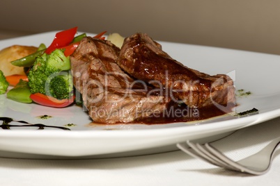 Close-up of filet mignon steak with vegetables