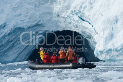 Close-up of people looking into ice cave