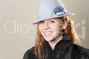 Close-up of redhead happy in blue hat