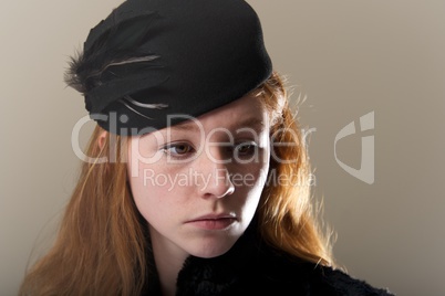 Close-up of redhead in black feathered hat