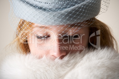 Close-up of redhead in blue veiled hat