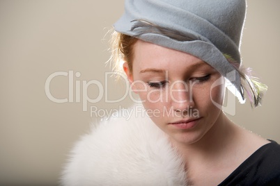 Close-up of redhead in fur looking down