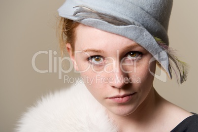 Close-up of redhead in hat looking up