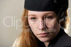 Close-up of serious redhead in black hat