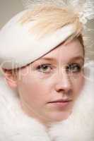 Close-up of serious redhead in cream hat