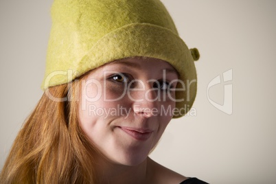 Close-up of smiling redhead in green hat