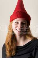 Close-up of smiling redhead in red hat