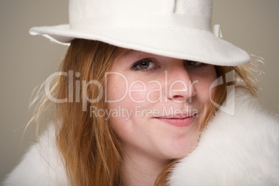 Close-up of smiling redhead in white hat