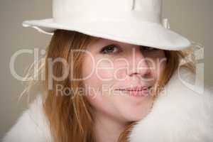 Close-up of smiling redhead in white hat