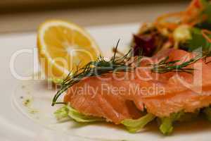 Close-up of smoked salmon platter with lemon