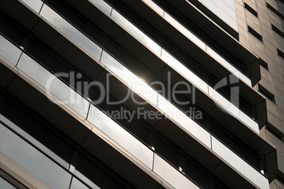 Close-up of sunlit glass and concrete skyscraper