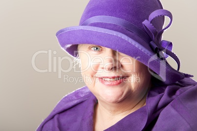 Close-up of white-haired woman in purple hat