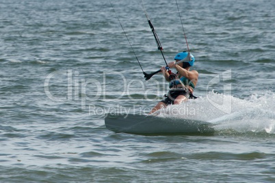 Female kite surfer in helmet leaning over