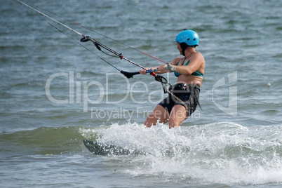 Female kite surfer looking away amid spray