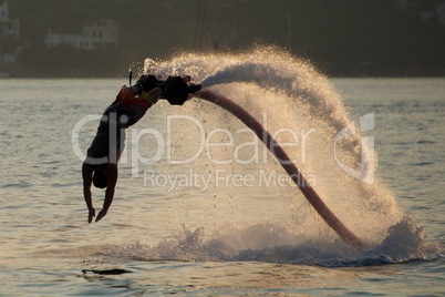 Flyboarder about to enter water with hands