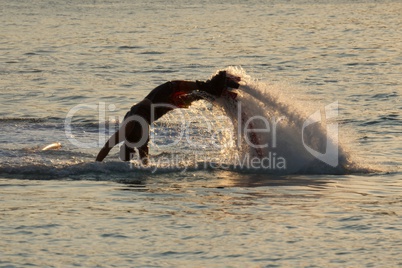 Flyboarder diving in up to his arms