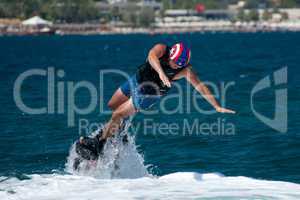Flyboarder falling into sea to his left