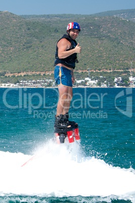 Flyboarder in helmet giving the thumbs up