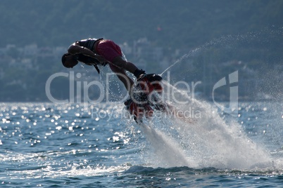 Flyboarder in pink shorts diving to left