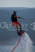 Flyboarder in pink shorts making spiral turn