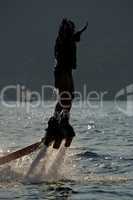 Flyboarder in profile with arms held out